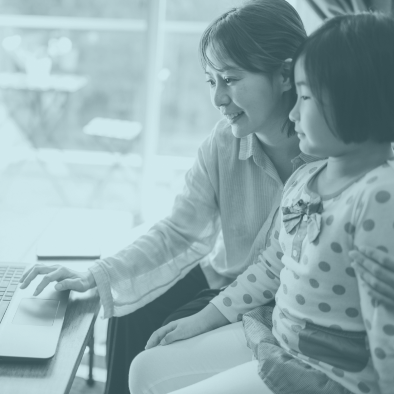 photo of a women and a young child looking at a laptop with blue-toned overlay