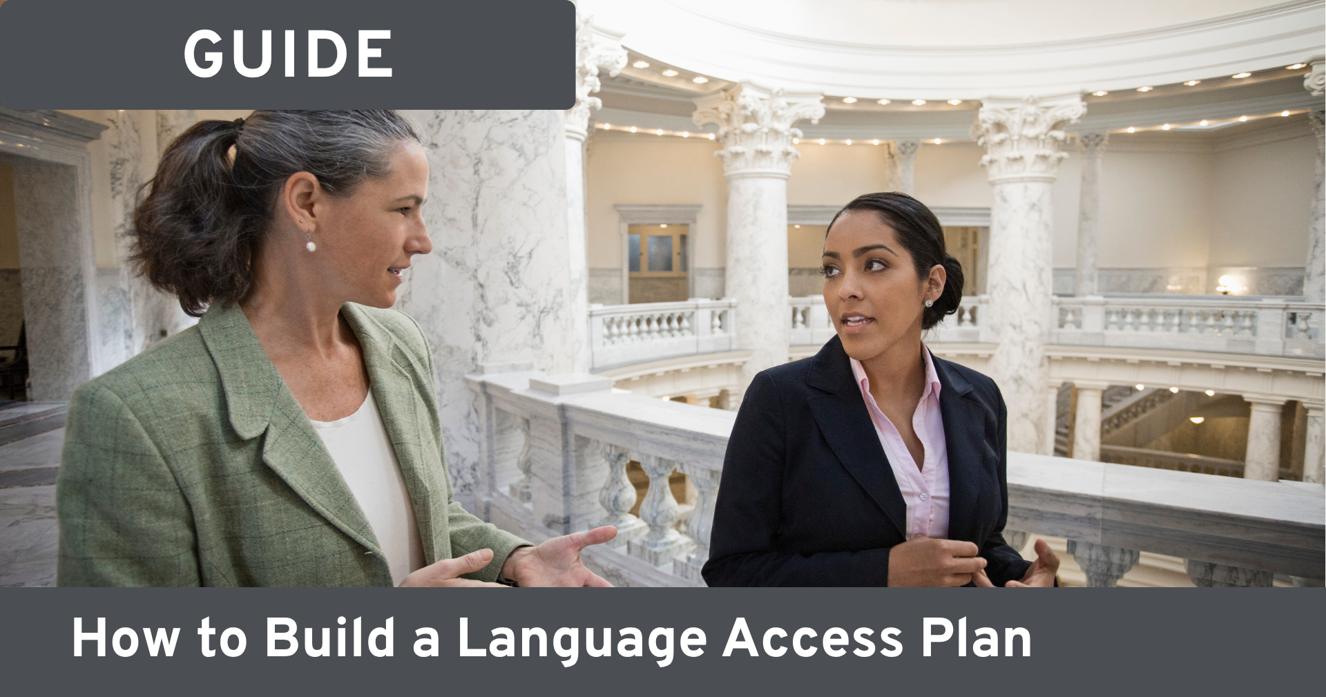 Two women walking and talking inside a government building that resembles a capitol. Text on image reads: 'Guide; how to build a language access plan.'