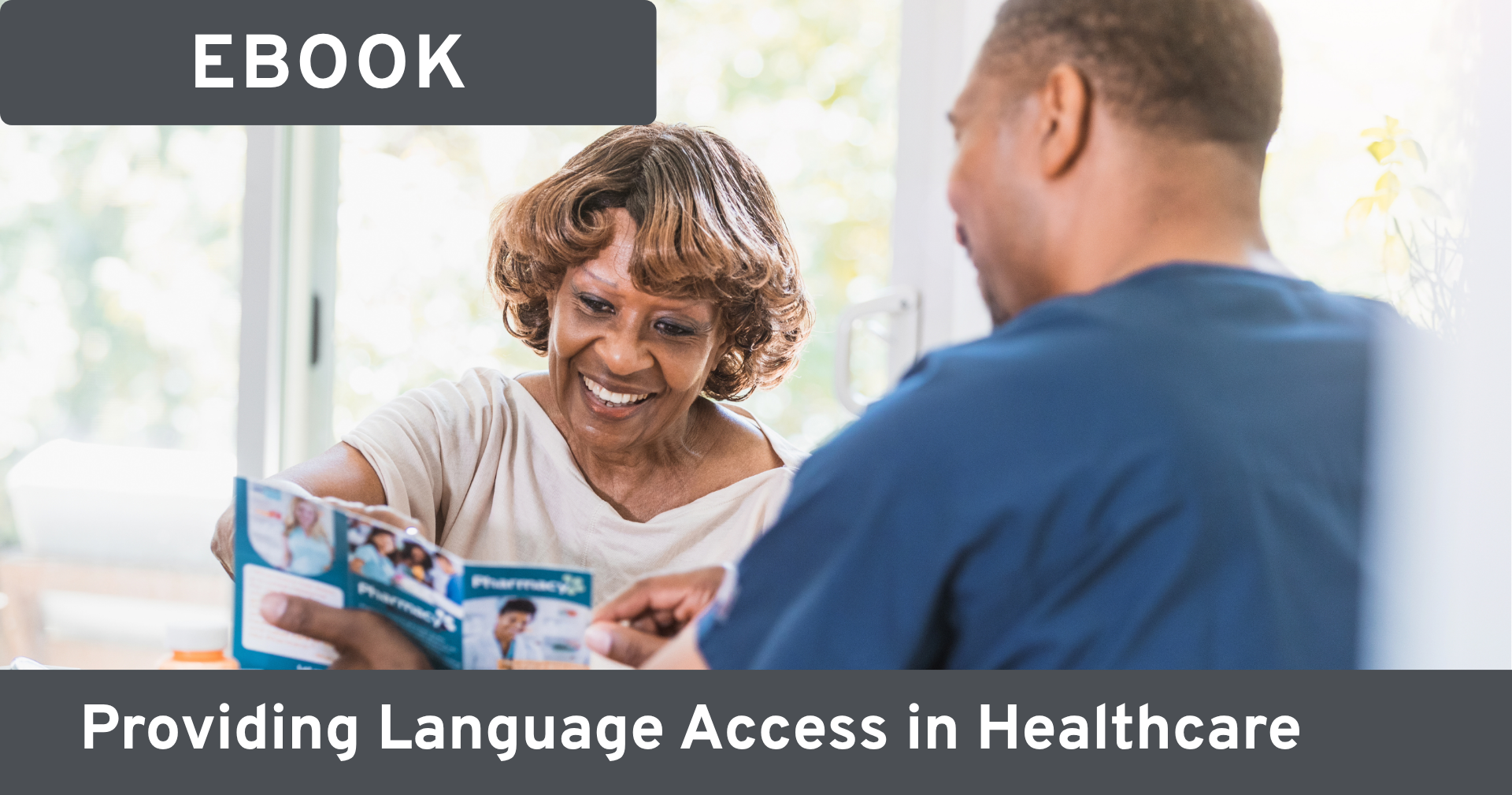 Man showing a brochure to a smiling woman as they talk together. Text on image reads: 'Ebook; providing language access in healthcare.'